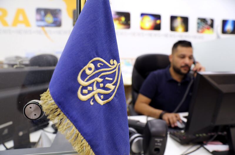 An employee works inside the office of the Qatar-based Al-Jazeera network in Jerusalem August 7, 2017. REUTERS/Ammar Awad