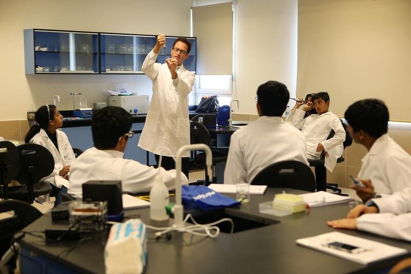 Sebastian Kraves, one of the miniPCR co-founders, shows students how to test food for bacterial contamination through DNA analysis during the Genes in Space workshop.