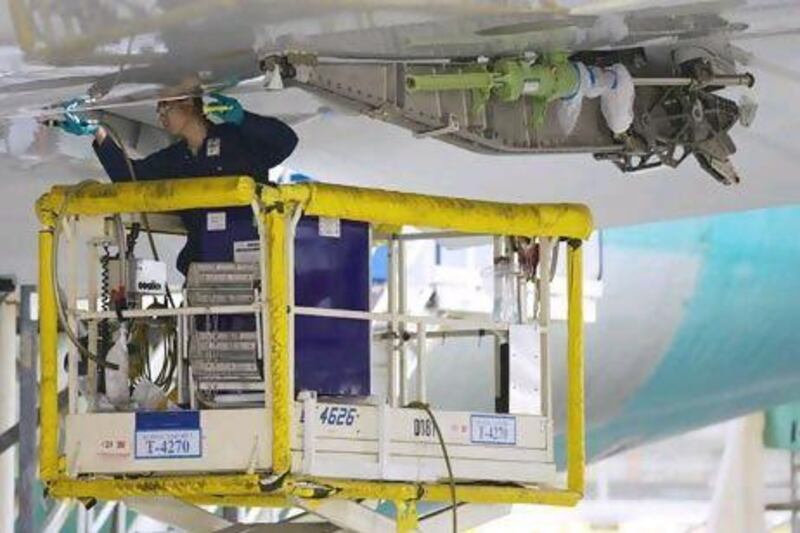 Strata has been sub-contracted to produce spoilers, the wing flaps that reduce lift and help control descents, for Boeing's 787 Dreamliner. Above, a Boeing technician works on a wing of an airplane being produced in Everett, Washington.