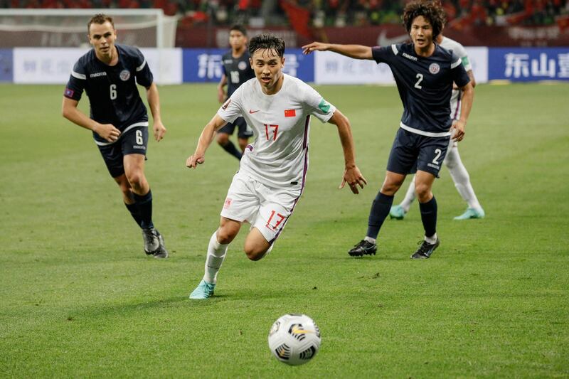 China's Wu Xinghan (C) fights for the ball during the 2022 World Cup football qualifier between China and Guam in Suzhou, in China's eastern Jiangsu province on May 30, 2021. China OUT
 / AFP / STR
