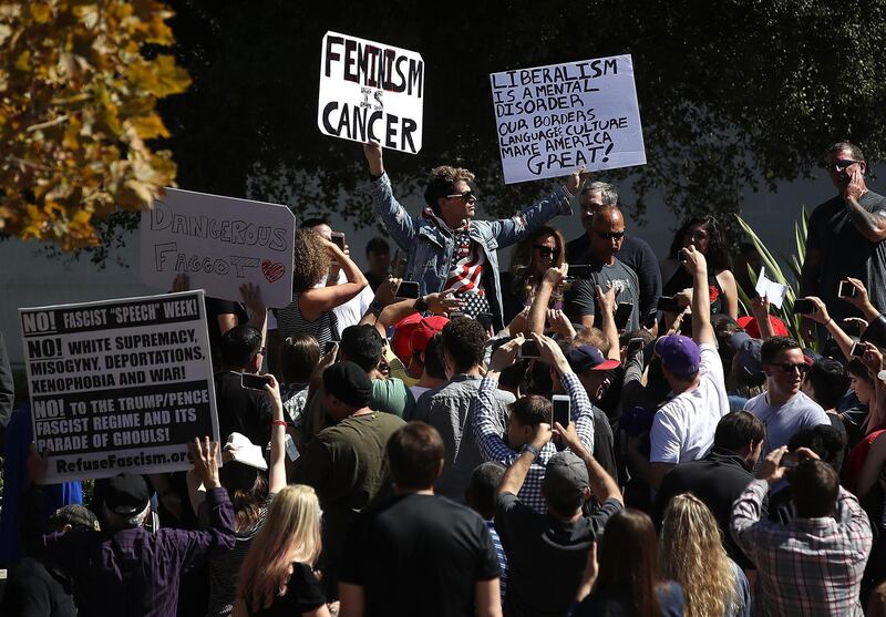 BERKELEY, CA - SEPTEMBER 24:  Right wing commentator Milo Yiannopoulos holds up signs as he spoke during a free speech rally at U.C. Berkeley on September 24, 2017 in Berkeley, California. Hundreds of protesters came out to support and demonstrate against Milo Yiannopoulos as he held a free speech rally at U.C. Berkeley.  (Photo by Justin Sullivan/Getty Images)