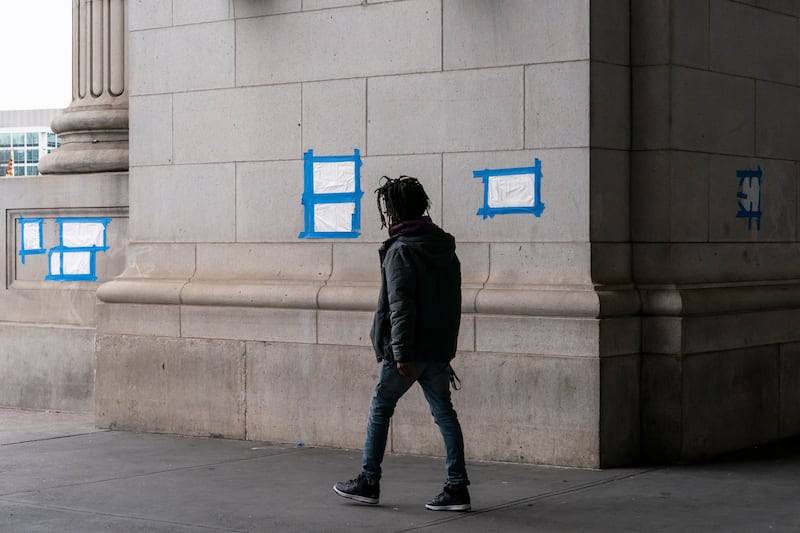 Blue tape and plastic cover swastikas drawn on the front of Union Station in Washington. AP