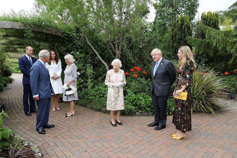Britain's Prime Minister Boris Johnson with his wife Carrie Johnson, right, along with Britain's Queen Elizabeth II, Prince Charles with Camilla, Duchess of Cornwall, and Prince William with Catherine, Duchess of Cambridge attend a reception in Cornwall. Reuters