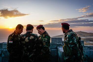 Peshmerga fighters discuss plans at an outpost in the Qara Chokh mountains in northern Iraq. Jack Moore / The National