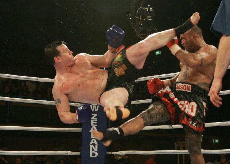 Peter Graham of Australia attacks Jason Suttie of Auckland with a rolling dragon kick in the final at the K1 Kings of Oceania Championship at ASB Stadium, Auckland, New Zealand. 16th July 2004. Peter Graham won the fight, defending his title. Sandra Teddy / Getty Images