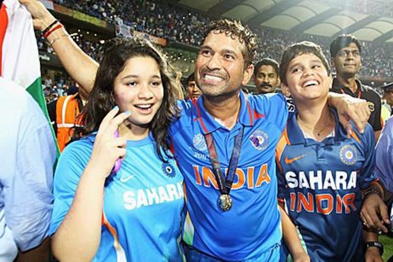After celebrating India’s World Cup victory on the field with his daughter, Sara, left, and his son, Arjun, right, Sachin Tendulkar says he’s having too much fun to retire.