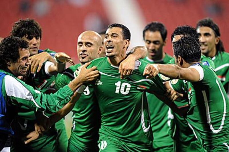 Younus Mahmood, centre, is congratulated after Iraq score in injury time.