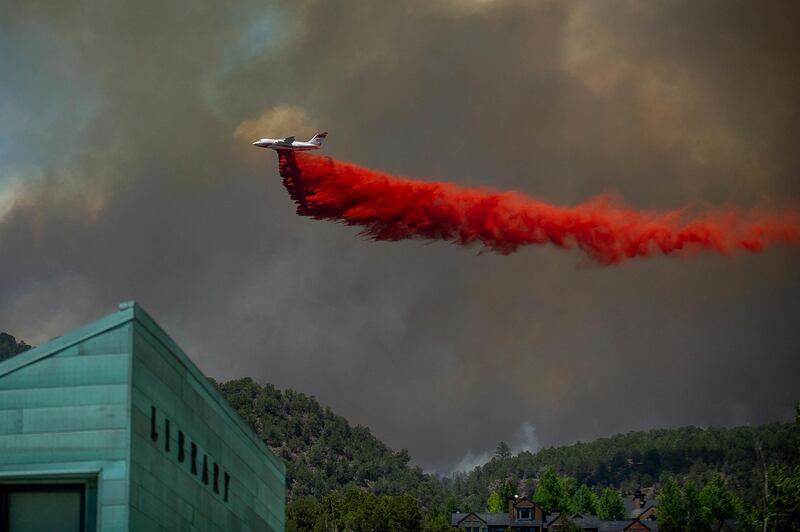 A plane drops fire retardant on homes in the area of Basalt, Colorado. Anna Stonehouse/AP Photo