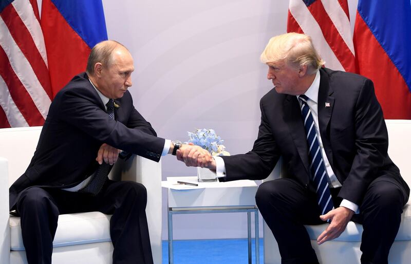 (FILES) In this file photo taken on July 7, 2017, US President Donald Trump and Russia's President Vladimir Putin shake hands during a meeting on the sidelines of the G20 Summit in Hamburg, Germany. A long-awaited summit between US President Donald Trump and his Russian counterpart Vladimir Putin will take place in Helsinki on July 16, the Kremlin said in a statement. "An agreement has been reached that on July 16 in Helsinki there will be a meeting between the President of the Russian Federation Vladimir Putin and the President of the United States Donald Trump," the statement said.
 / AFP / SAUL LOEB
