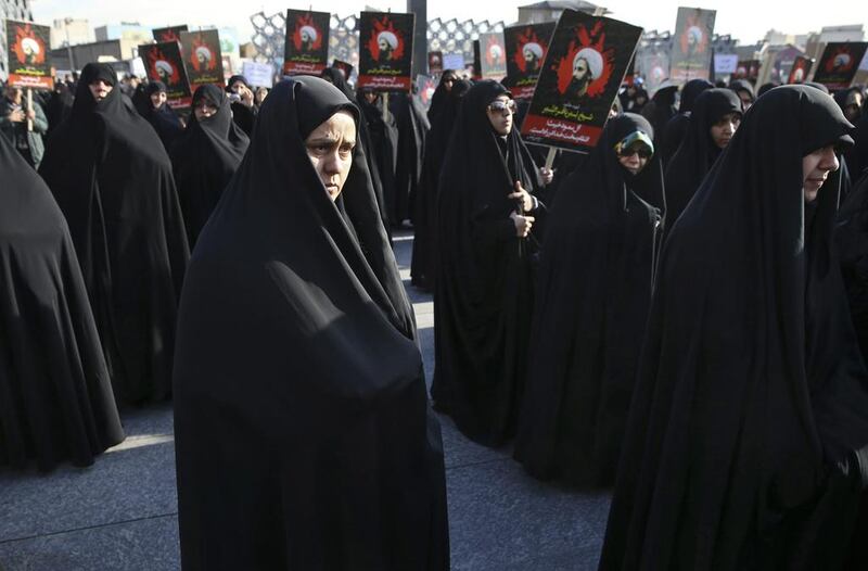 Women attend a rally in Tehran, Iran, on Monday, Jan. 4, 2016, to protest Saudi Arabia's execution of Sheikh Nimr al-Nimr, a prominent opposition Shiite cleric, seen in posters. (AP Photo/Vahid Salemi)