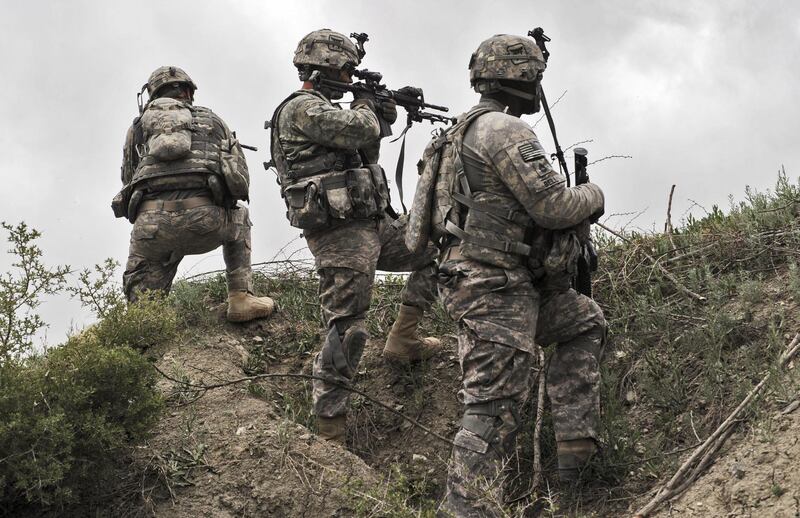 (FILES) In this file photo US soldiers from Second Platoon, Bravo Troop, 33rd Cavalry, 3rd Brigade Combat Team take position during a patrol in Ibrahim Khel village of Khost province on April 11, 2010.  President Joe Biden will remove all US troops from Afghanistan before this year's 20th anniversary of the September 11 attacks, ending America's longest war around five months later than planned, a US official said.
Biden has "reached the conclusion that the United States will complete its drawdown -- will remove its forces from Afghanistan -- before September 11," the official told reporters on condition of anonymity. / AFP / MASSOUD HOSSAINI
