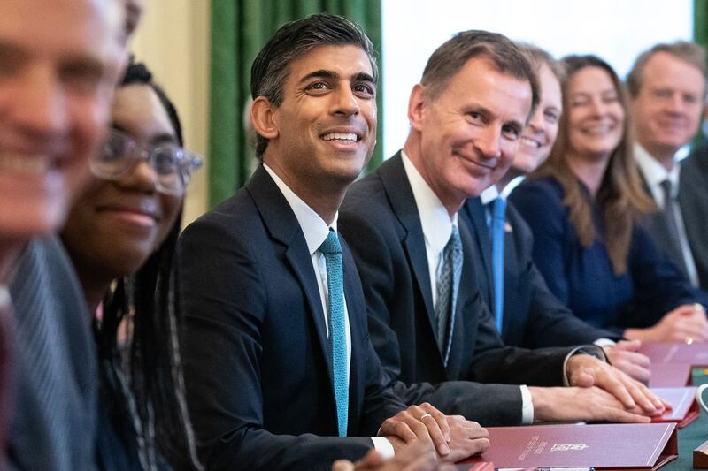 Britain's Prime Minister Rishi Sunak, centre, alongside Britain's Chancellor of the Exchequer Jeremy Hunt, centre right, at Number 10 Downing Street. AFP