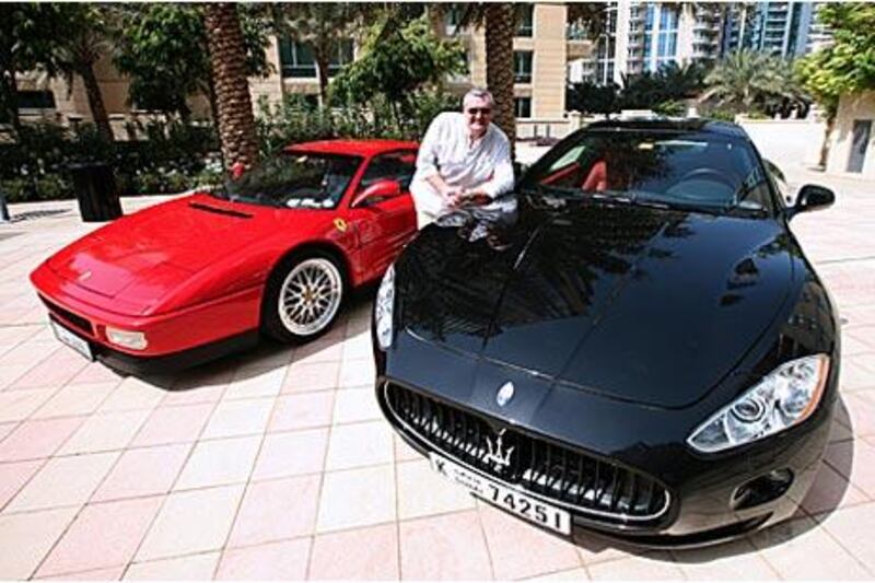 Mike Brownhill with his brand-new Gran Turismo Maserati, his everyday car, and his classic 1989 red Ferrari, which he takes out at weekends, at Dubai Marina.