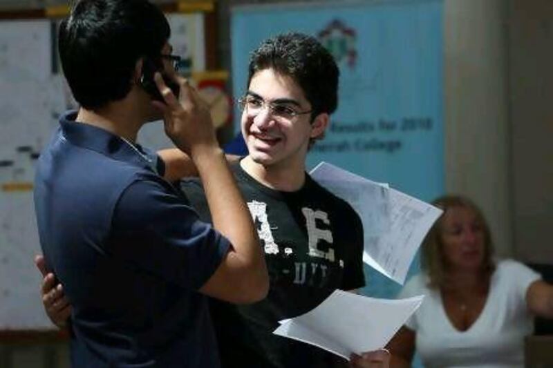 Fahar Al-Said, left, and Salman Abdul Jalil, an 18-year-old Emirati, congratulate each other after collecting their A-level results.