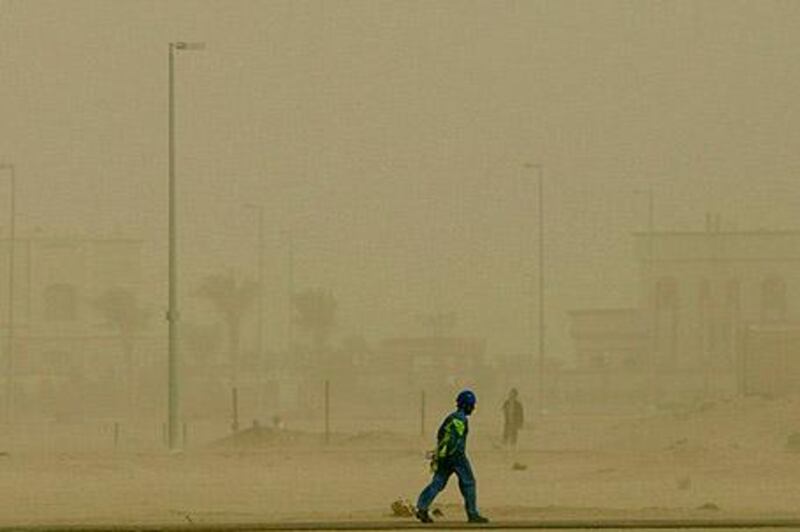 February 4, 2010 / Abu Dhabi / (Rich-Joseph Facun / The National) A man makes his way through the sand storm while working in Khalifa City B, Thursday, February 4, 2010 in Abu Dhabi. The storm depleted the standard level of visibility along routes through the emirates. 