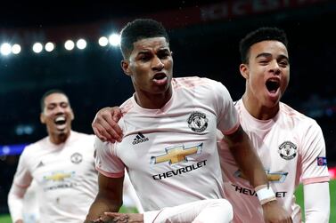 Manchester United's Marcus Rashford, centre, celebrates scoring against PSG at the Parc des Princes Stadium in Paris. Ian Langsdon / EPA