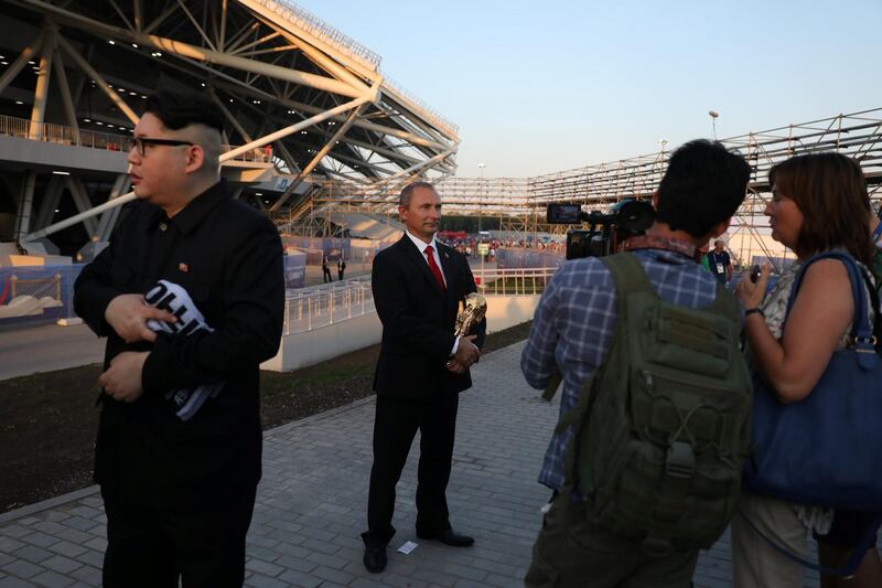 Men impersonating North Korean leader Kim Jong Un and Russian President Vladimir Putin are interviewed by members of media at the stadium in Samara. Pilar Olivares / Reuters