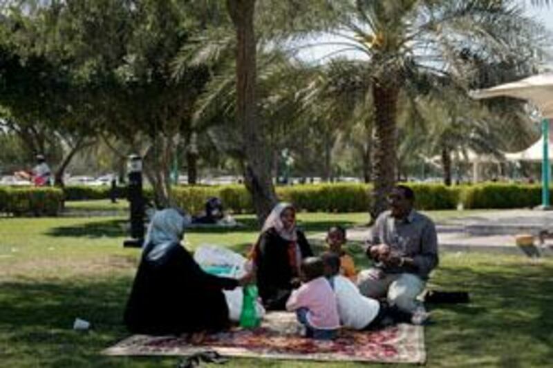 ABU DHABI, UNITED ARAB EMIRATES - March 7, 2009: Adults (right) Abdelati Al Fadil, (left) Khalda Atoum, (center) Lubna Osman all family and friends picnick together in Apple Garden park off Airport Road in Abu Dhabi.
( Ryan Carter / The National )