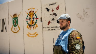 A soldier of the Spanish contingent of UNIFIL stands in front of the ensign of his regiment on a UNIFIL base close to Ghajar on the Blue Line separating Israel from Lebanon in southern Lebanon. Oliver Marsden for The National