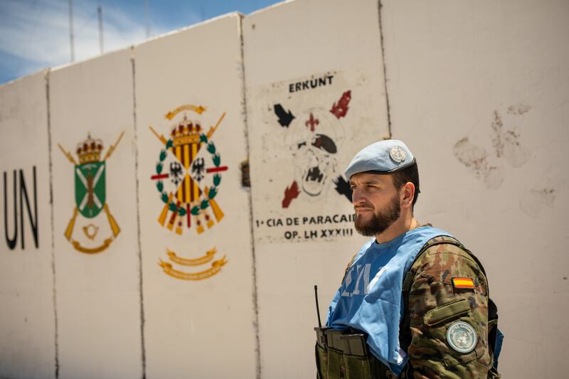 A soldier of the Spanish contingent of Unifil stands in front of the ensign of his regiment on a Unifil base close to Ghajar on the Blue Line separating Israel from Lebanon in southern Lebanon. All photos: Oliver Marsden for The National