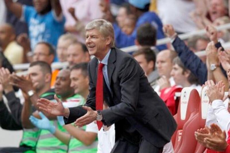 Arsenal manager Arsene Wenger celebrates after Alex Song (unseen) scored their third goal during their English Premier League soccer match against Bolton Wanderers at the Emirates Stadium in London September 24, 2011.    REUTERS/Eddie Keogh (BRITAIN - Tags: SPORT SOCCER) FOR EDITORIAL USE ONLY. NOT FOR SALE FOR MARKETING OR ADVERTISING CAMPAIGNS. NO USE WITH UNAUTHORIZED AUDIO, VIDEO, DATA, FIXTURE LISTS, CLUB/LEAGUE LOGOS OR "LIVE" SERVICES. ONLINE IN-MATCH USE LIMITED TO 45 IMAGES, NO VIDEO EMULATION. NO USE IN BETTING, GAMES OR SINGLE CLUB/LEAGUE/PLAYER PUBLICATIONS