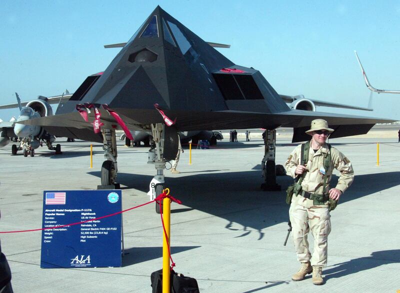 A US soldier guards a Nighthawk F-117A at the Dubai Air show  09 December 2003. The United States, Britain and France are jointly setting up with the United Arab Emirates (UAE) a military air flight training centre in Dubai that could eventually lead to joint exercises by Gulf countries, Egypt and Jordan, a US Air Force official told AFP. The Air Warfare Center, which will be set up at the UAE's Al-Dhafra Airbase, will be owned and run by the Emirati government, said Major David Halla at Dubai's eighth air show. AFP PHOTO/Rabih MOGHRABI / AFP PHOTO / RABIH MOGHRABI