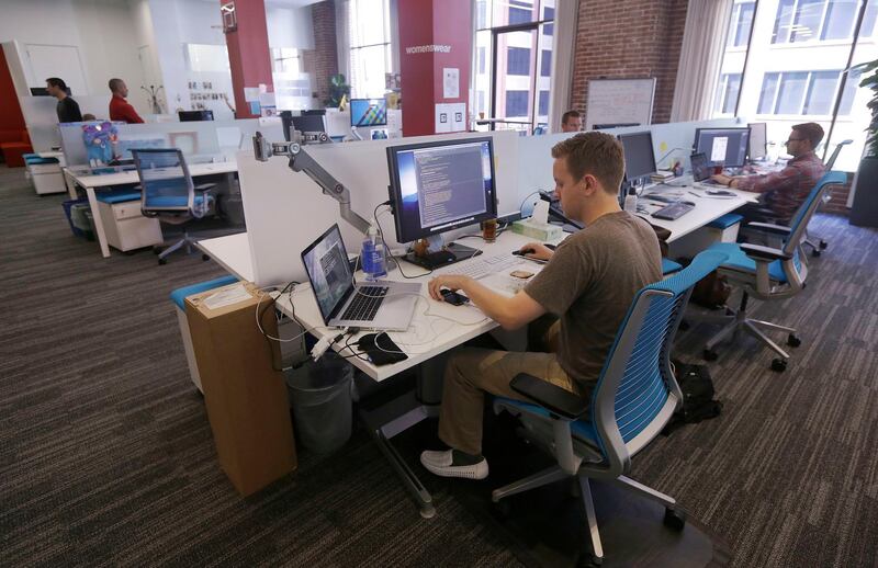 FILE- This Sept. 19, 2013, file photo shows workers at the Target Technology Innovation Center office in San Francisco. According to Fidelity Investments data, millennial long-term participants in a 401(k) now have an average balance of over $100,000. The secret to their success isnâ€™t high salaries or rich parents. Itâ€™s consistency. (AP Photo/Jeff Chiu, File)