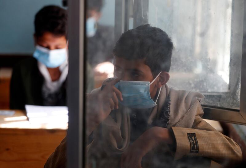epa08610135 Students wear masks as they take final school exams amid the ongoing coronavirus pandemic, at a school in Sana'a, Yemen, 18 August 2020.  EPA/YAHYA ARHAB