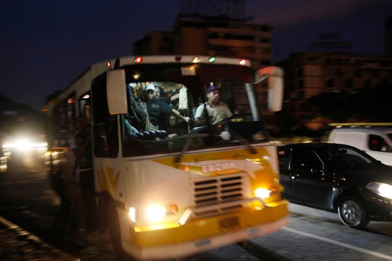 A public transportation bus is packed with passengers during a blackout in Caracas, Venezuela, Monday, July 22, 2019. The lights went out across much of Venezuela Monday, reviving fears of the blackouts that plunged the country into chaos a few months ago as the government once again accused opponents of sabotaging the nation's hydroelectric power system. (AP Photo/Ariana Cubillos)