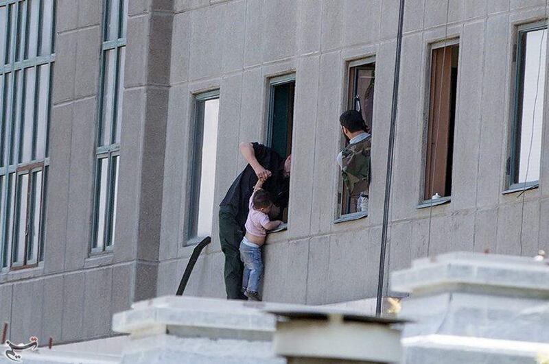 A boy is evacuated during the attack on the Iranian parliament in central Tehran. Tasnim News Agency / Handout via Reuters