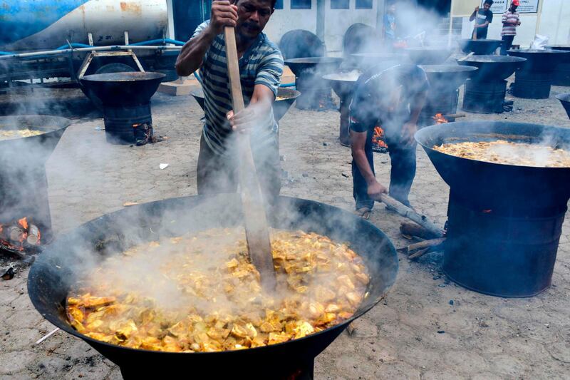 Men cook traditional curries before Muslims break their fast at a mosque during Ramadan in Banda Aceh, Indonesia. AFP