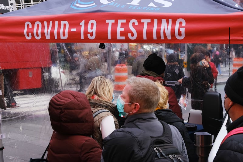 People wait in line to get tested for Covid-19 in Times Square, New York. AFP