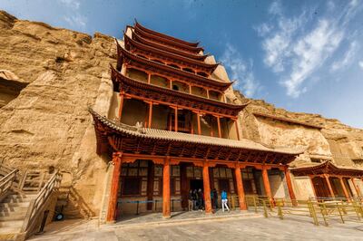 epa07060832 A general view of the Mogao Caves in Dunhuang, Gansu Province, China, 26 September 2018, (issued 01 October 2018). Dunhuang is a city in northwestern Gansu Province, Western China. City was major stop on the ancient Silk Road, established in an oasis which contains Crescent Lake and had strategic position on a crossroads of the Southern Route of Silk Road and main road from India trough Tibet and Mongolia to Southern Siberia. Donhuang is tourist destination best known for Crescent Lake, Mogao Caves, Yardang Geopark and desert with countless sand dunes which are merging to stone composed desert and mountains. At winter temperature riches -25 C and sand dunes become frozen with tops covered in snow. Mogao Caves are located 25 km form Dunhuang. Buddhist caves are famous for their Buddhist art such as murals inside, Buddhist statues and Dunhuang manuscripts found hidden in a sealed-up cave. There is 735 of them. Crescent Lake is a crescent-shaped lake in an oasis, 6 km south of the city. Lake is top tourist attraction and landmark in Donhuang where dune sledding, camel or SUV ride, helicopter flight or dune hiking are offered to visitors. Reports say Dunhuang city of about 200 000 population, accommodate 10 million visitors during a year. Yardang Geopark also known as Devilâ€™s Town and part of it as Ghost Town, is located 180 kilometers northwest of Dunhuang. The park contains rock formations of unique shape developed over a period of 700,000 years. When there are no wind visitors experience soundless environment while walking between rock formations of witch some are naturally shaped to remind viewer on peacock, buddha, camel etc. Yardang covers area of abut 400 square kilometers and its part of UNESCO protected areas.  EPA/ALEKSANDER PLAVEVSKI
