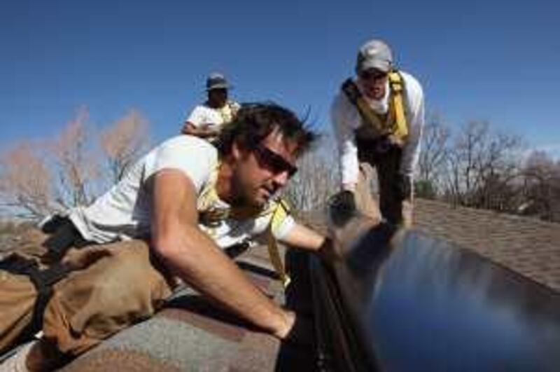 BOULDER, CO - MARCH 04: Kevin Gillette, an installer for Namaste Solar, connects a solar panel to the roof of a residence on March 4, 2009 in Boulder, Colorado. Renewable energy companies such as Namaste expect to benefit from additional funding for green intiatives included in the recently passed federal economic stimulus package. Blake Jones, CEO of the Boulder-based, employee-owned Namaste, introduced President Barack Obama when he visited Denver to sign the economic stimulus bill in February.   John Moore/Getty Images/AFP