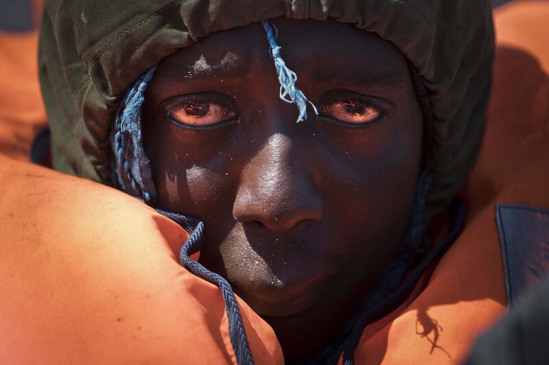 A migrant is rescued from a rubber boat in the Mediterranean Sea by members of Proactiva Open Arms NGO, about 90 kilometres north of Sabratha, Libya. Bernat Armangu / AP / April 6, 2017