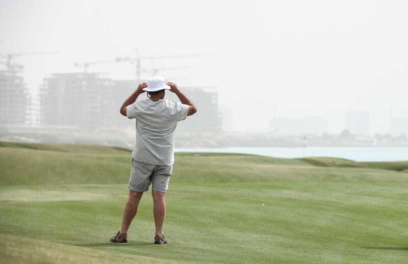 Abu Dhabi, United Arab Emirates - Spectators enjoy the golf despite the windy weather at Yas Links Golf Club. Khushnum Bhandari for The National
