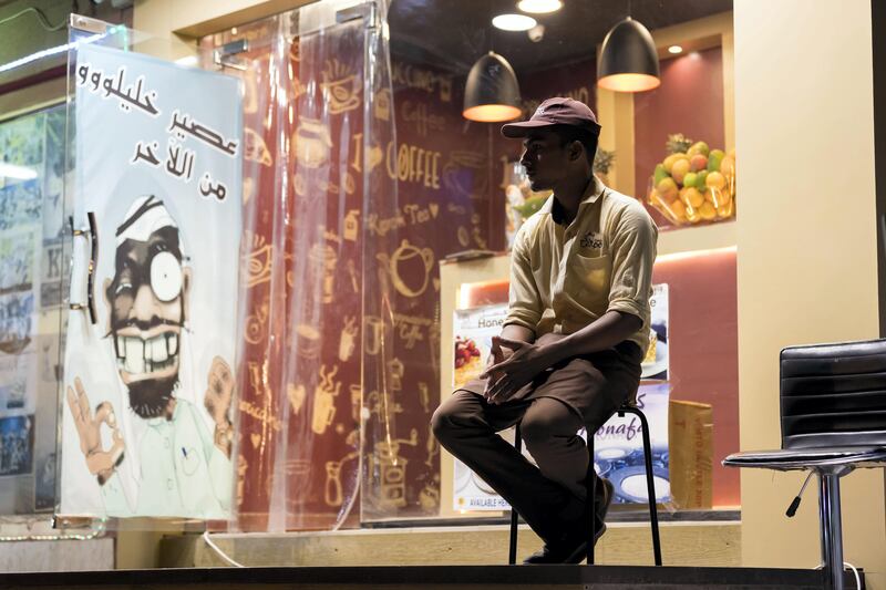 Ras Al Khaimah, United Arab Emirates - September 20th, 2017: A worker outside the Teapot cafe. A traditional fishing neighbourhood in Old RAK has been transformed by karak coffee and tea shops that have popped up in the last two years. Wednesday, September 20th, 2017, Old RAK, Ras Al Khaimah. Chris Whiteoak / The National