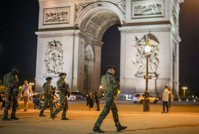 French soldiers, part of the national security plan 'Vigipirate', keep watch as they secure the area near the Arc de Triomphe, in Paris, France, early 03 July 2023.  Violence broke out all over France after police fatally shot a 17-year-old teenager during a traffic stop in Nanterre on 27 June.  The French Interior Ministry released a provisional bulletin for 02 July reporting, on the fifth night of rioting, 719 people arrested nationwide and 45 police officers or gendarmes injured.   EPA / OLIVIER MATTHYS
