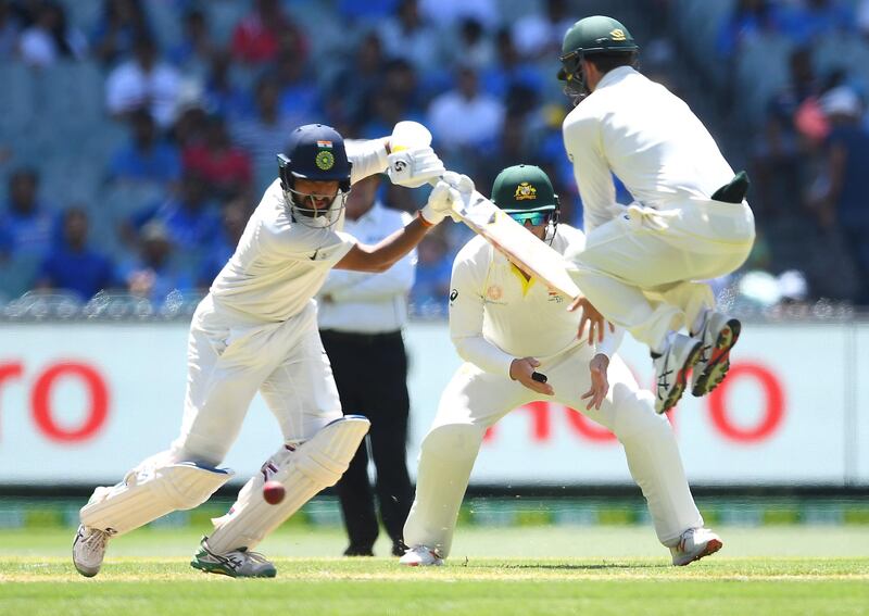 MELBOURNE, AUSTRALIA - DECEMBER 27: Cheteshwar Pujara of India bats as Travis Head of Australia jumps out of the way in the field during day two of the Third Test match in the series between Australia and India at Melbourne Cricket Ground on December 27, 2018 in Melbourne, Australia. (Photo by Quinn Rooney/Getty Images)