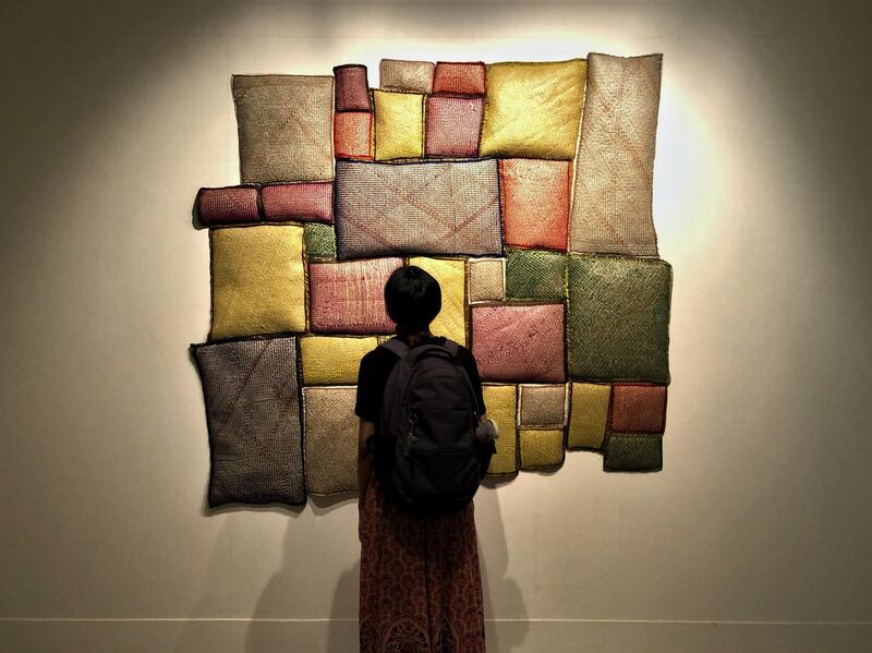 A visitor in front of Ashfika Rahman's work at Dhaka Art Summit. Alexandra Chaves / The National