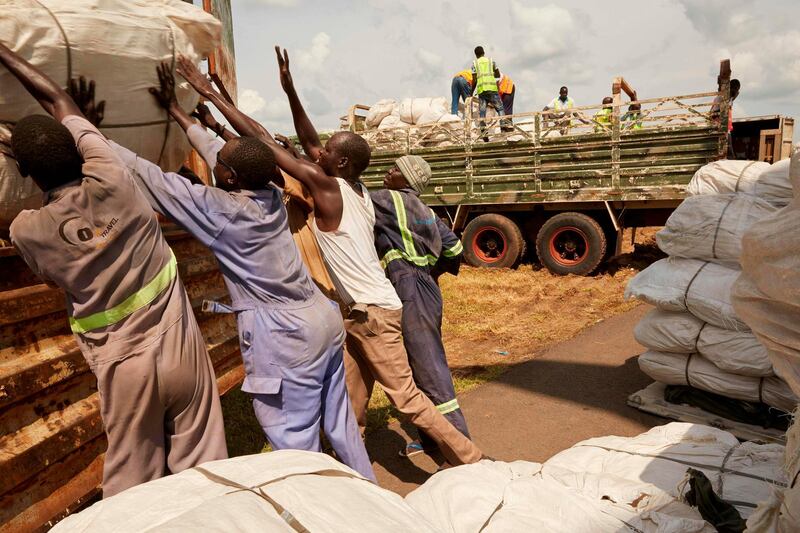 Workers load material onto a military truck in Juba  after a cargo plane loaded with 300 tents and 3200 military uniforms arrived today from Cairo as a contribution towards the cantonment plans of South Sudan’s military and opposition forces.  AFP
