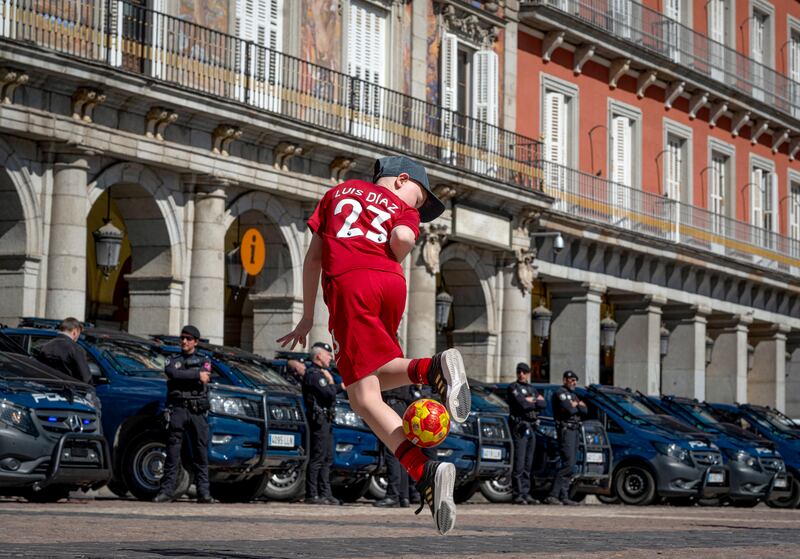 A young Liverpool supporter shows his ball skills as fans gather in the Spanish capital before Real Madrid beat the English side at the Santiago Bernabeu. EPA
