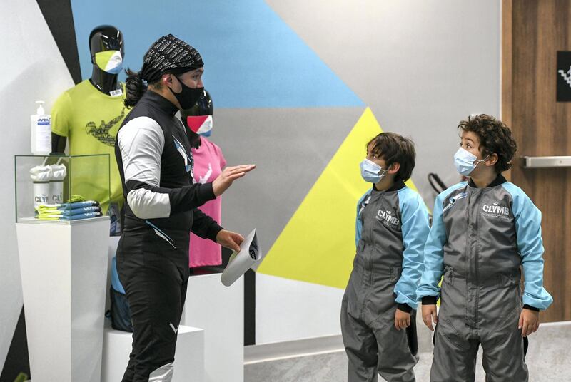 Abu Dhabi, United Arab Emirates - Mazen, 7, and Samih, 9, receive Certificates from the instructor after their indoor skydiving adventure at CLYMB, Yas Island. Khushnum Bhandari for The National