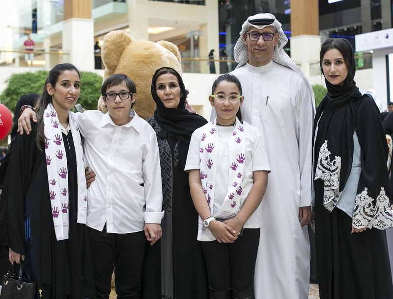 Sharif Al Shami celebrates Down Syndrome Day with his family at Yas Mall. His son, Omar (second left), has Down Syndrome. Mona Al Marzooqi/ The National
