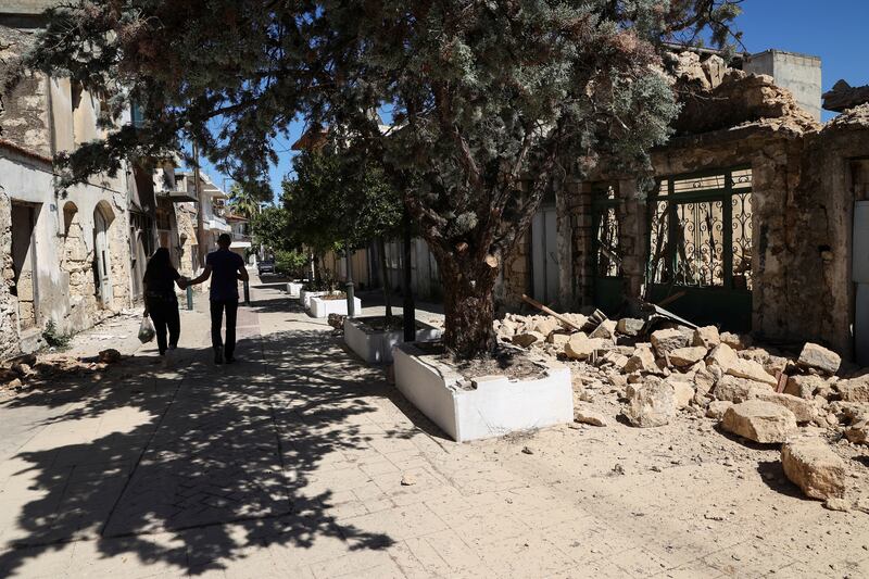 People walk past rubble following Monday's earthquake on the island of Crete. Photo: Reuters