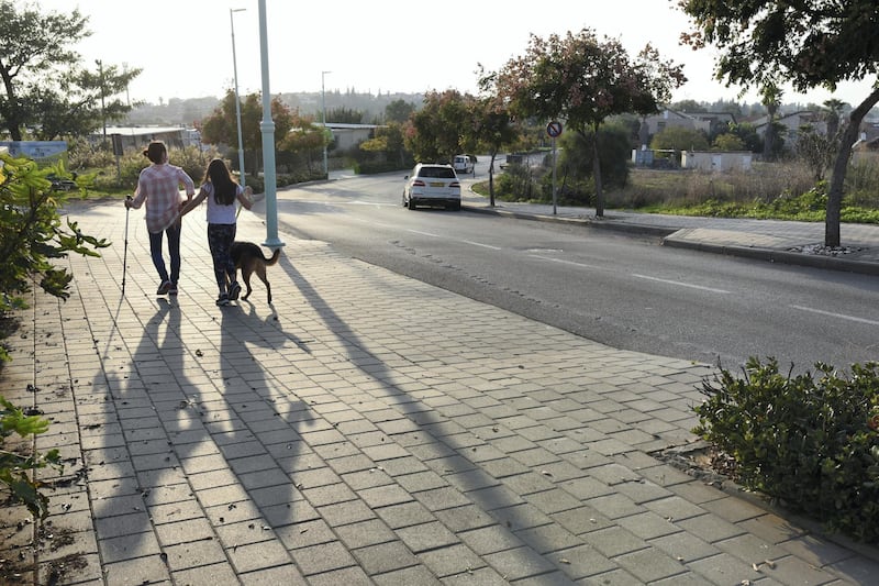 Roni Weingarten and her daughter Rotem, 10, walk their dog in Oranit settlement. Rose Scammell for The National