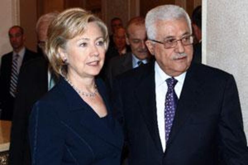 A handout picture from the Palestinian Press Office shows the Palestinian president Mahmud Abbas standing with US Secretary of State Hillary Clinton prior to a meeting in Abu Dhabi.