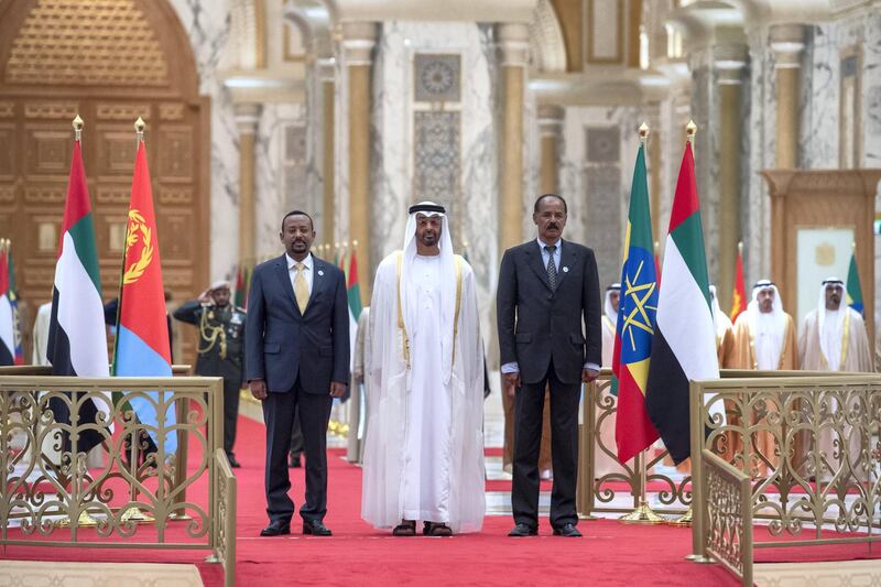 ABU DHABI, UNITED ARAB EMIRATES - July 24, 2018: HH Sheikh Mohamed bin Zayed Al Nahyan Crown Prince of Abu Dhabi Deputy Supreme Commander of the UAE Armed Forces (C), HE Dr Abiy Ahmed, Prime Minister of Ethiopia (L) and HE Isaias Afwerki, President of Eritrea (R), stand for the UAE national anthem during a reception at the Presidential Palace. 

( Hamad Al Kaabi / Crown Prince Court - Abu Dhabi )
---