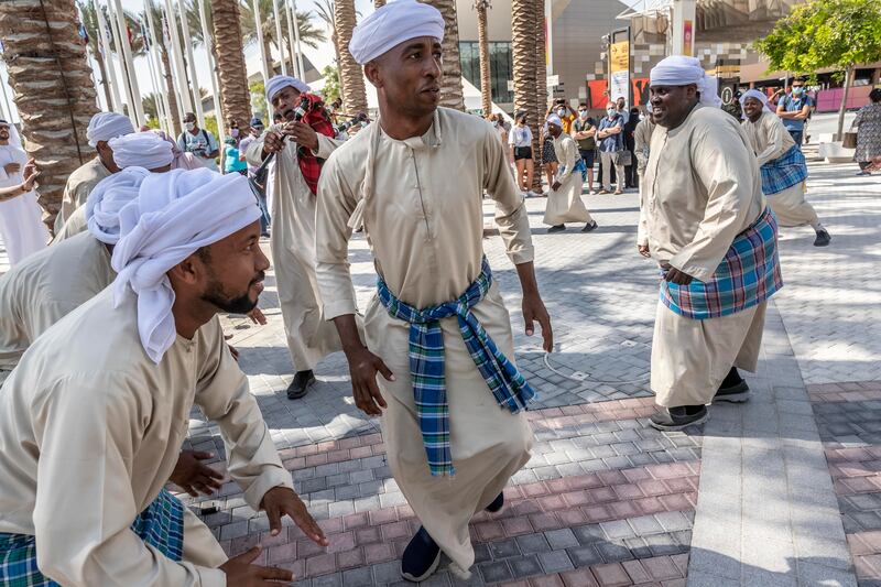 Emiratis and Omanis perform a traditional dance with traditional instruments native to the border areas that the two countries share.  Antonie Robertson / The National