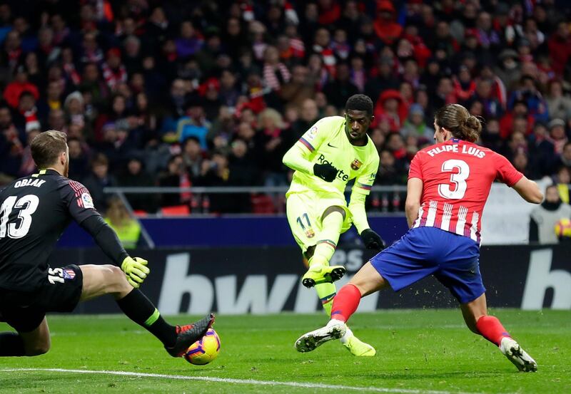 Barcelona's Ousmane Dembele, center, scores his side's opening goal during a Spanish La Liga soccer match between Atletico Madrid and FC Barcelona at the Metropolitano stadium in Madrid, Saturday, Nov. 24, 2018. (AP Photo/Manu Fernandez)
